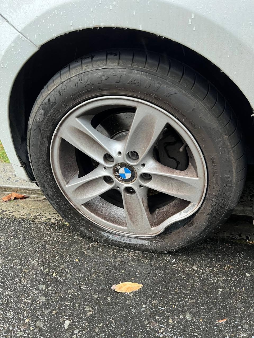 Damaged BMW mag wheel with a bent rim before repair