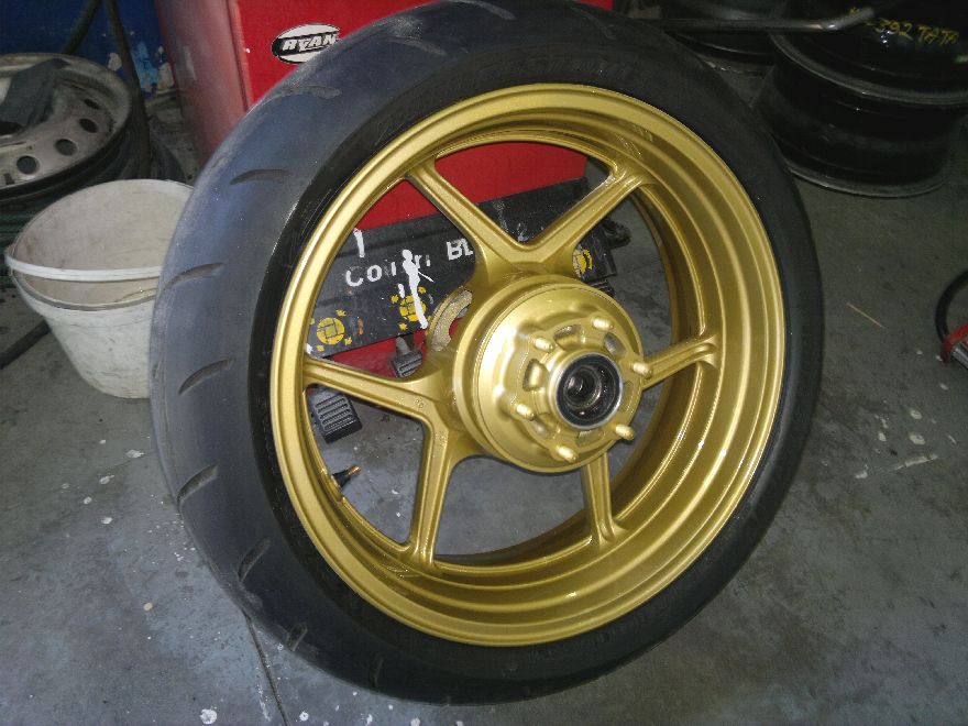 Gold motorcycle wheel after refurbishment