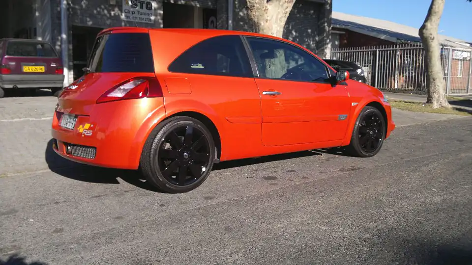 Orange Renault Megane RS outside the workshop