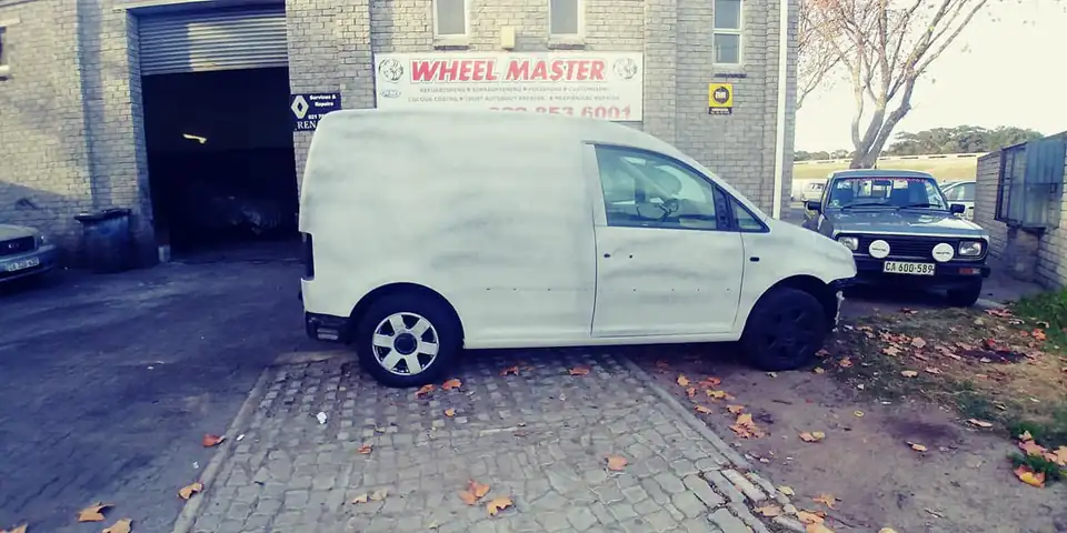 Finished white VW Caddy outside the workshop