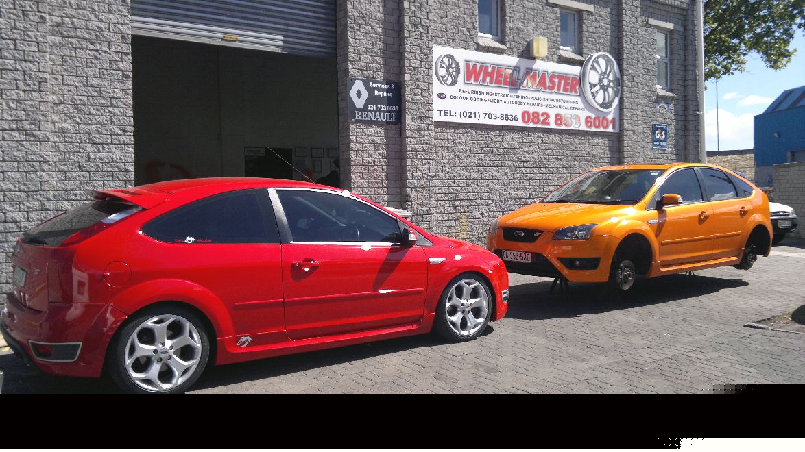 Customer cars outside the Wheel Master workshop in Ottery